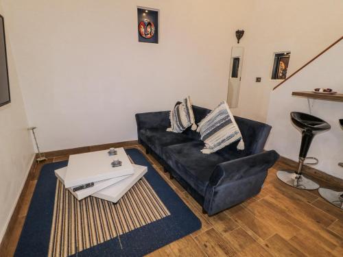 a living room with a black couch and a table at Derrywilligan in Newry