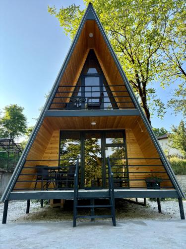a triangular house with a window and a table at Wooden House Martvili in Martvili
