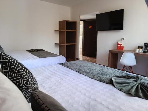 Postel nebo postele na pokoji v ubytování Hotel Las Pergolas