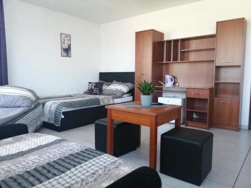 a living room with two beds and a table at Adria in Sarbinowo