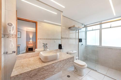 a bathroom with a sink and a toilet and a shower at Hotel Trianon Paulista in Sao Paulo