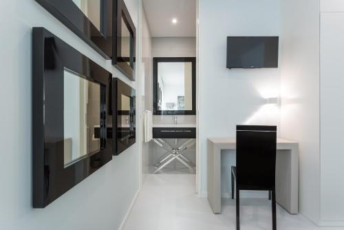 a dining room with a table and a mirror at House Barra Beach in Praia da Barra