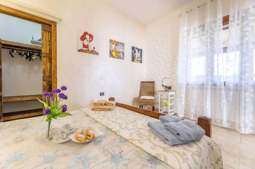 a bedroom with a large bed with towels on it at B&B Pilella in Alliste