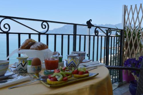 a table with a tray of food on a balcony at B&B Fronte Del Mare in Salerno