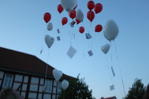 a bunch of red and white balloons flying in the sky at Hotel Alte Posthalterei in Creuzburg
