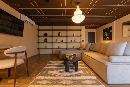 a living room with a couch and a table at Agara Stays Prizren in Prizren