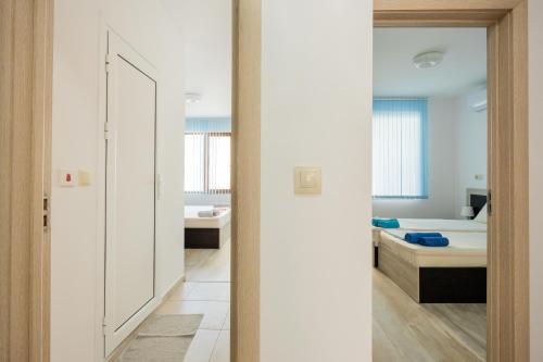 a room with a bedroom and a bed and a mirror at Marea 1 in Pomorie