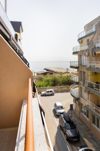 a view from the balcony of a building with a parking lot at Marea 1 in Pomorie