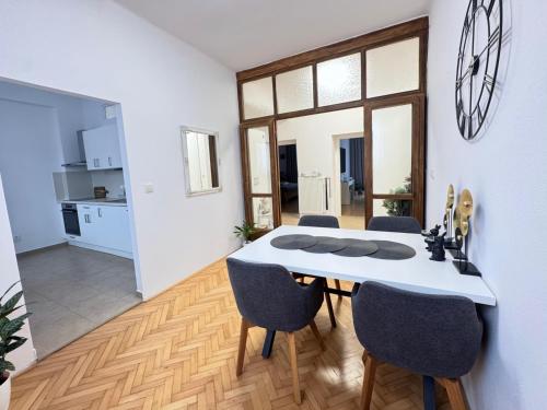 a dining room with a white table and chairs at Apartmán Dlouhá 207 in Litoměřice