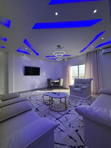 a living room with blue lights on the ceiling at GLC Appartement in Nouakchott