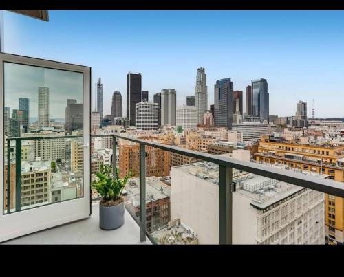 a balcony with a view of a city skyline at 3-Bed High-Rise with Panoramic Views, Pool & Spa in Los Angeles