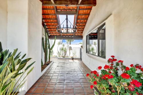 a hallway with red flowers and a ceiling with a chandelier at Luxury 5 bedroom Wine Retreat Fallbrook Villa sleeps 12 in Fallbrook