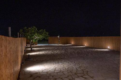 a parking lot with a fence at night at TSABAS BEACH SIDE APARTMENTS ΤΣΑΜΠΑΣ παραλιακά διαμερίσματα 1 in Kyllini