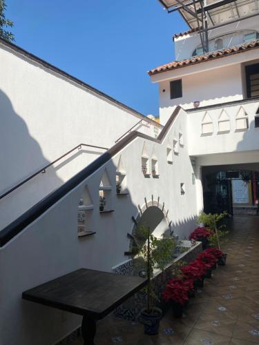 a balcony with a table and a building at Casa Yollotzin in Ajijic