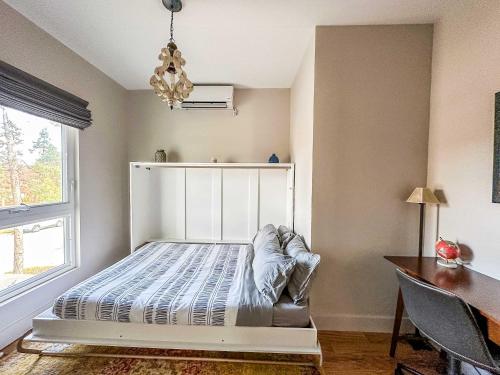 a bedroom with a bed and a desk and a window at The 4M Favorite House - Stunning & Spotless 2-Bed Apt (#3) in Ann Arbor