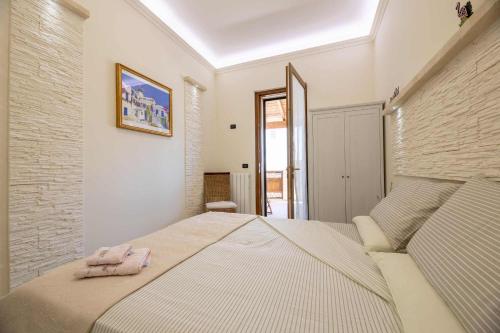 a bedroom with a bed with a towel on it at B&B Pilella in Alliste