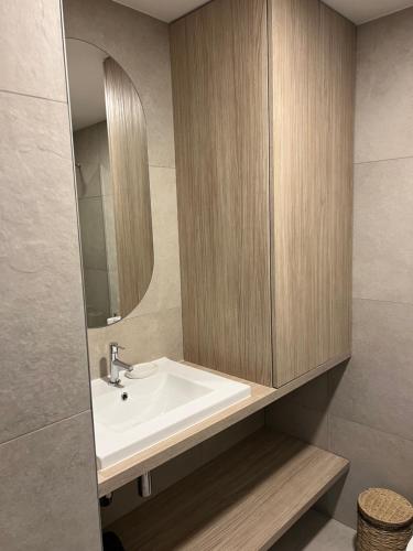 a bathroom with a sink and a mirror at Nida & Sunrise *Self Check-In* in Nida