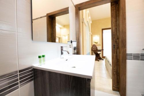 a bathroom with a white sink and a mirror at B&B Pilella in Alliste