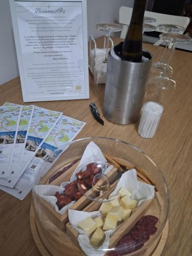 a table with a plate of food and a bottle of wine at Rei Túzaro in Milladoiro