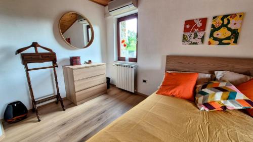 a bedroom with a bed and a mirror at Holiday House Calla, house with a view, near Piran in Sečovlje