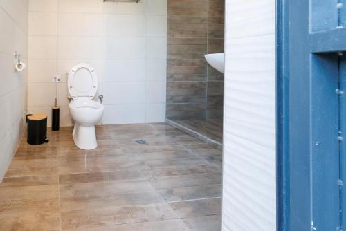 a bathroom with a toilet and a sink at House Alexandros in Asprovalta