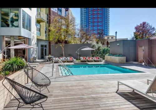 a patio with a pool and chairs and a swimming pool at Modern 2BR Near Petco Park & Convention Center in San Diego