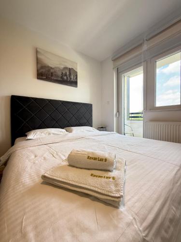 a bedroom with a bed with two towels on it at Kovan Lux 9 Sokobanja in Soko Banja