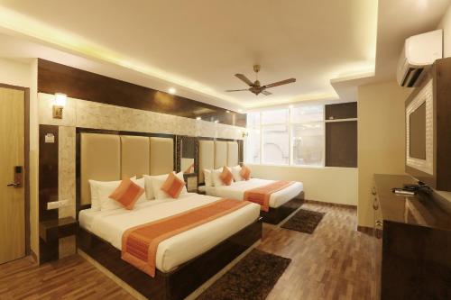 Postel nebo postele na pokoji v ubytování Hotel Plazzo At Delhi International Airport