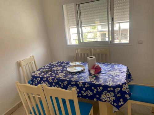 a dining room table with a blue and white table cloth at Appartement de luxe à Saidia in Saidia 