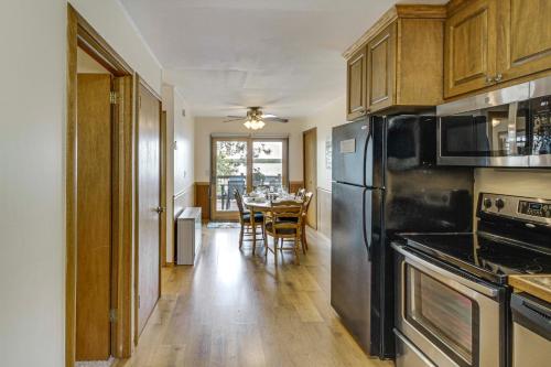 a kitchen with black appliances and a table with chairs at Family Retreat on Cross Lake Boat, Swim and Relax! in Cross Lake