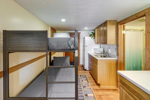 a small kitchen with a bunk bed in a room at Family Retreat on Cross Lake Boat, Swim and Relax! in Cross Lake