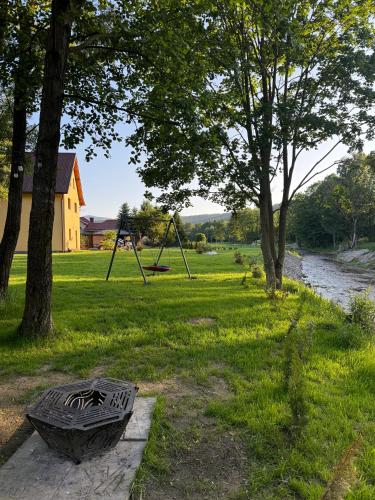 a park with a swing set and a playground at Zajazd Stodoła sauna w cenie in Stronie Śląskie