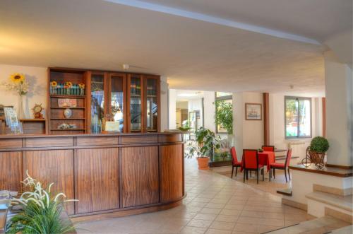 a lobby with a waiting area with red chairs at Hotel Villa Lina in Loano