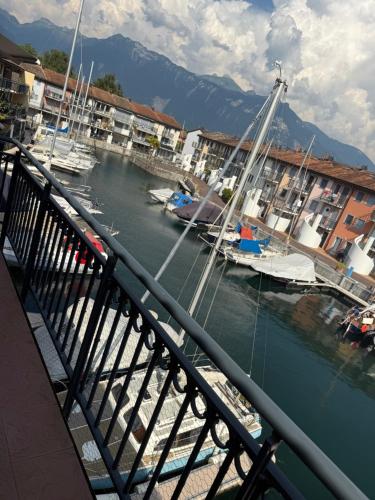 a marina with boats in the water and buildings at BnB la Vague in Port-Valais