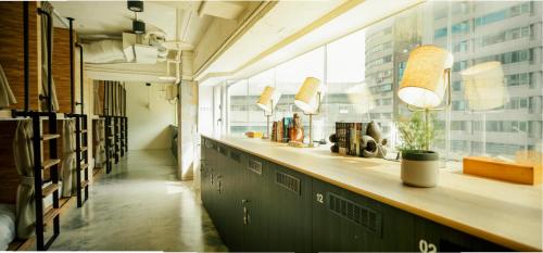 a long counter in a room with a window at NK Hostel in Taipei