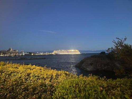 a view of the ocean with a city in the distance at 2 bedroom suint water front in Victoria