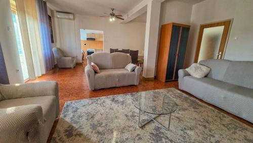 a living room with a couch and chairs and a table at Holliday house Lidia in Brioni Maggiore