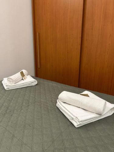 a bed with white towels sitting on top of it at Sweet Room MARY in Santa Maria Maddalena