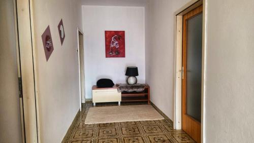 a hallway with a room with a table and a lamp at Holliday house Lidia in Brioni Maggiore