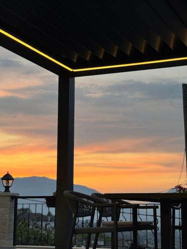 a view of the sunset from the porch of a house at Castle Hotel in Gjirokastër