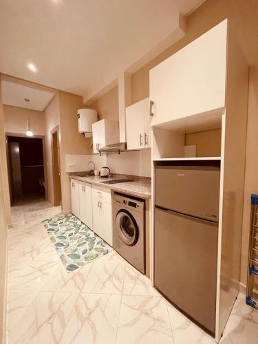 a kitchen with a washing machine and a washer at Relax Family 05 - Cozy Entire Apartment in City Center in Ouarzazate