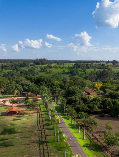 an aerial view of a road with palm trees at SR Farm Hotel in Brotas