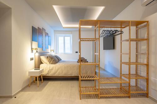 a bedroom with a bed and a wooden bunk ladder at Spinedi Royale in Postalesio