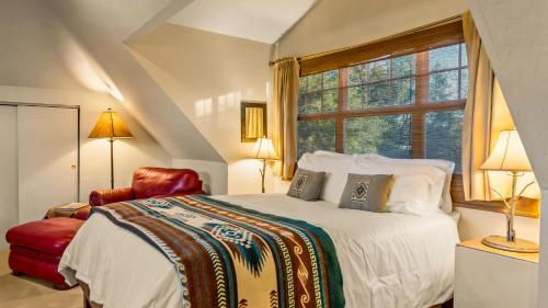 a bedroom with a large bed and a window at Tubac Country Inn in Tubac