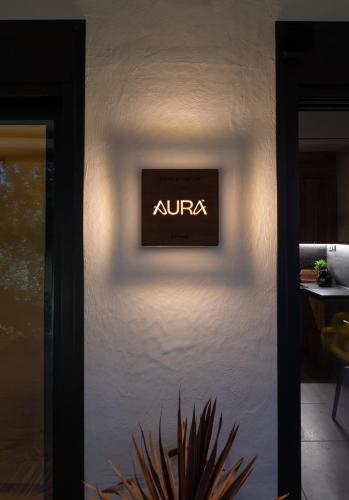 a sign on the side of a wall at AURA sophisticated living in Nea Kalikratia