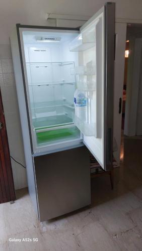 an open refrigerator with a bottle of milk in it at Nicolas Dream in Nea Makri