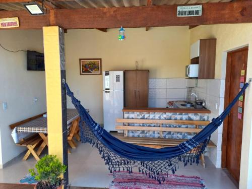 a hammock in the kitchen of a house at Casa na praia in Caraguatatuba