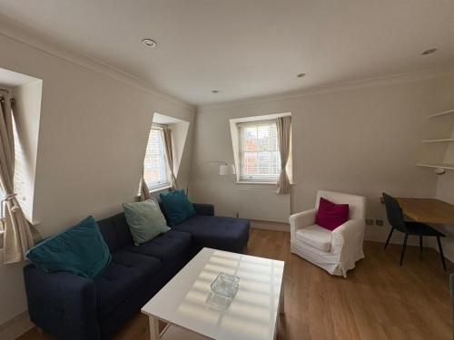 a living room with a couch and a table at The Orderly By Estatesmen in London