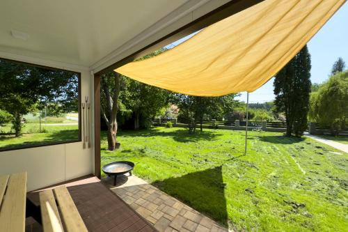 a screened in porch with a bench and a window at Apartmány Stříbřec 146 in Jindrichuv Hradec