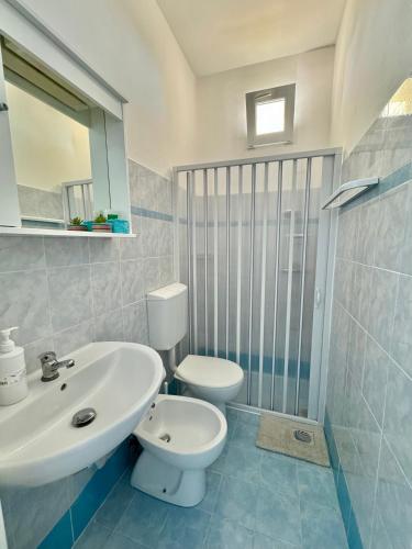a bathroom with a white sink and a toilet at Dimora Il Girasole in Torre San Giovanni Ugento